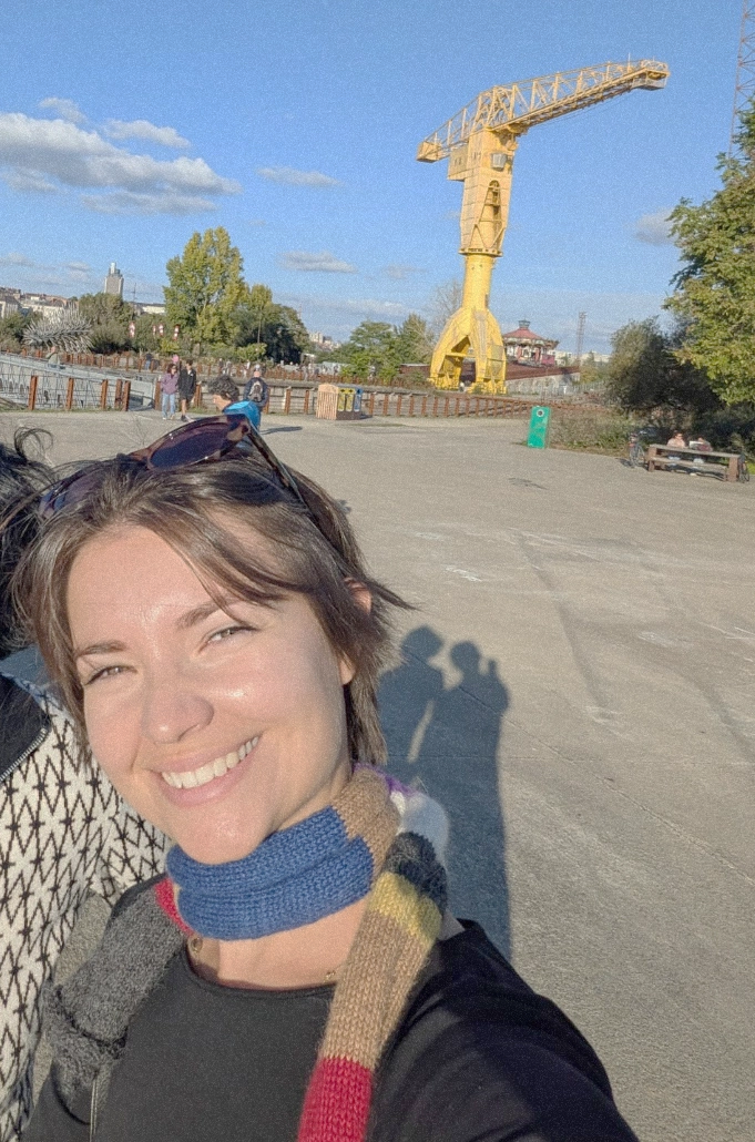 Alexia in an urban space with a yellow crane